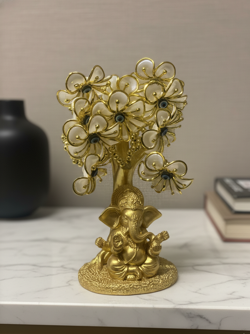 Gold decorative statue with floral elements on a marble surface