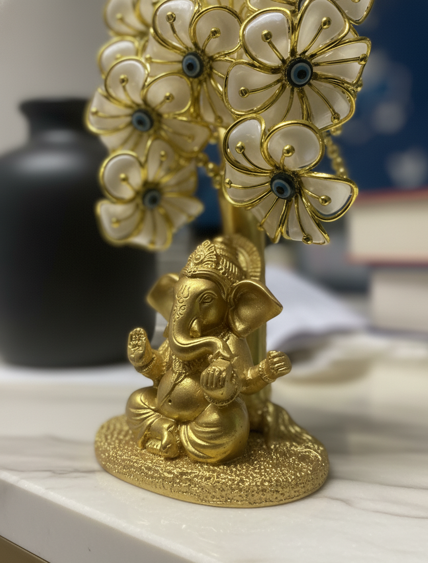 Gold statue of a deity with white flowers on a marble surface